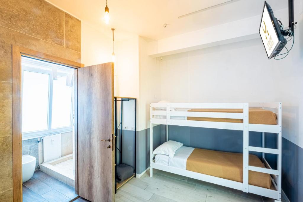 a small room with bunk beds and a bathroom at My Tiny Home in Rome