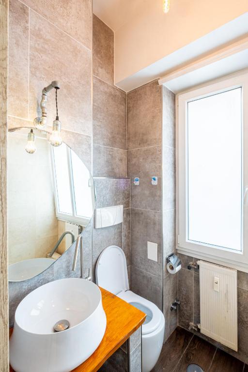 a bathroom with a sink and a toilet and a window at My Tiny Home in Rome
