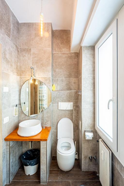 a bathroom with a toilet and a sink at My Tiny Home in Rome