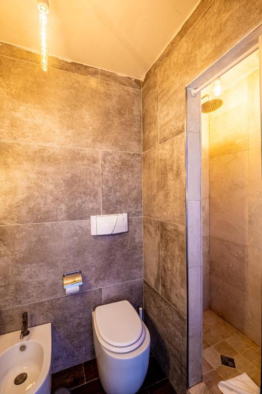 a bathroom with a toilet and a sink and a shower at My Tiny Home in Rome