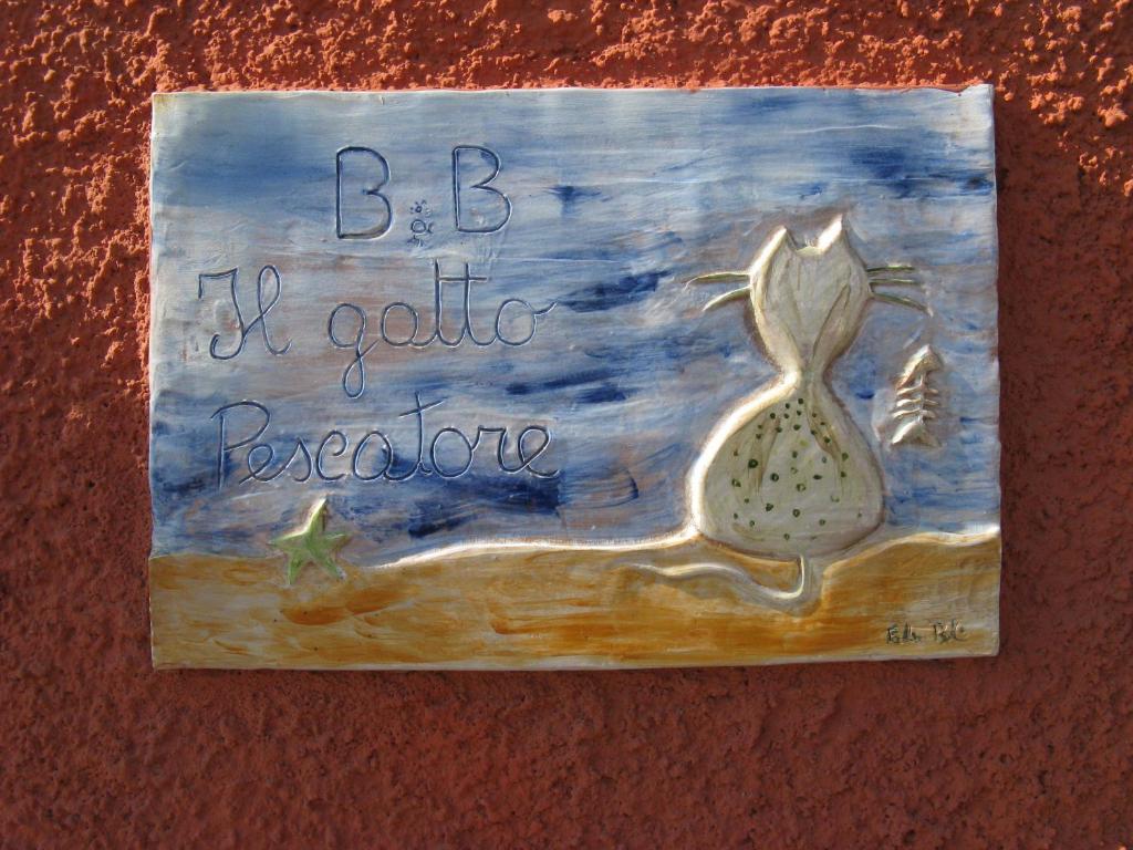 a painting of a mermaid on a wall at B&B Il Gatto Pescatore in Stintino