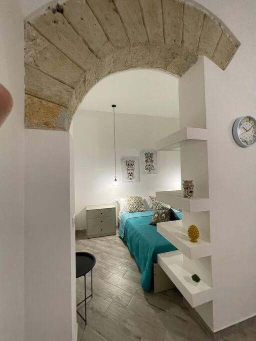 a bedroom with a bed and a table in a room at Sea sicily home in Santa Flavia