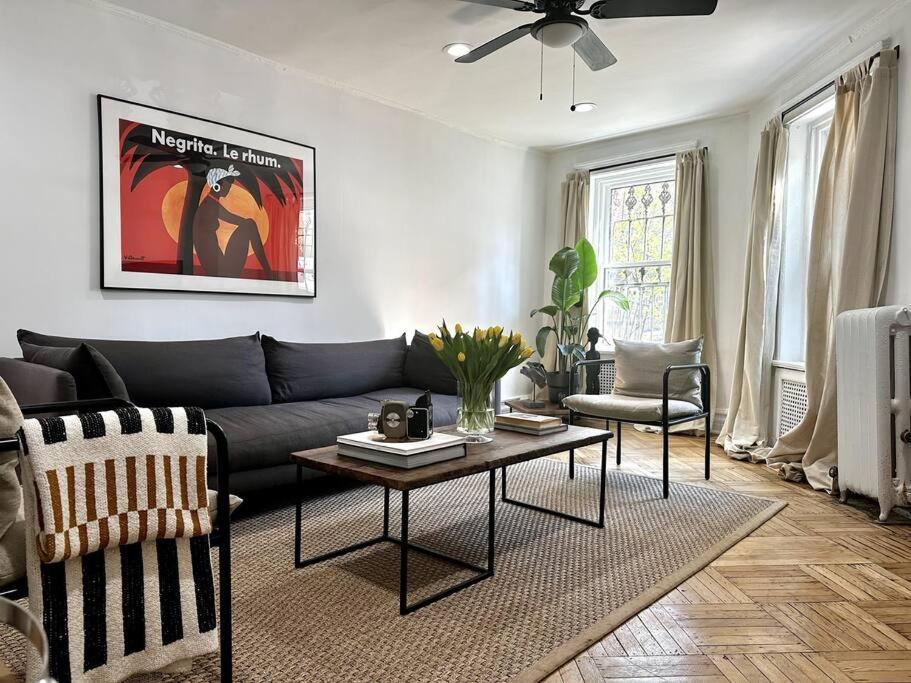 a living room with a couch and a table at Crown Heights Charmer with private backyard access in Brooklyn