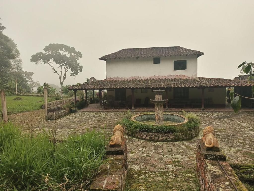 a house with a fountain in front of it at Posada Filo Alto 