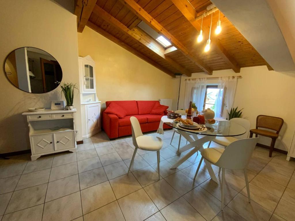 a living room with a red couch and a table at Lory apartment in Bardolino