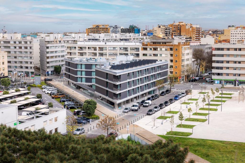 a city with cars parked in a parking lot at Four Points by Sheraton Matosinhos in Matosinhos
