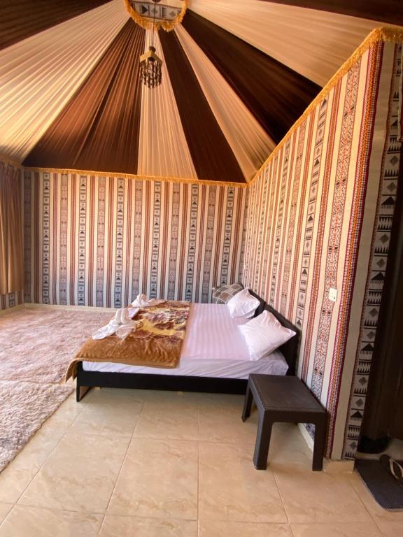 a bedroom with a bed in a tent at WADi RUM NOOR CAMP in Wadi Rum