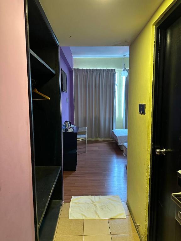 Postel nebo postele na pokoji v ubytování De Choice Hotel Tawau