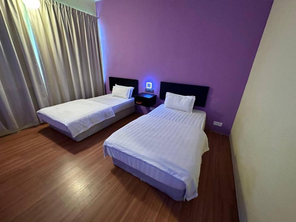 Postel nebo postele na pokoji v ubytování De Choice Hotel Tawau