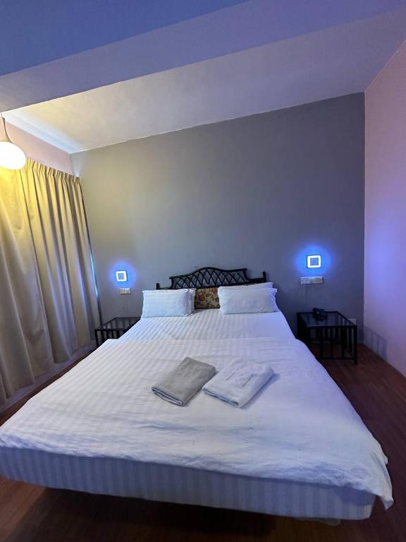 Postel nebo postele na pokoji v ubytování De Choice Hotel Tawau