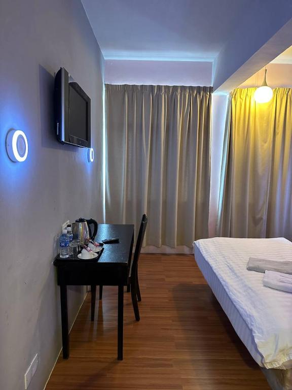 Postel nebo postele na pokoji v ubytování De Choice Hotel Tawau