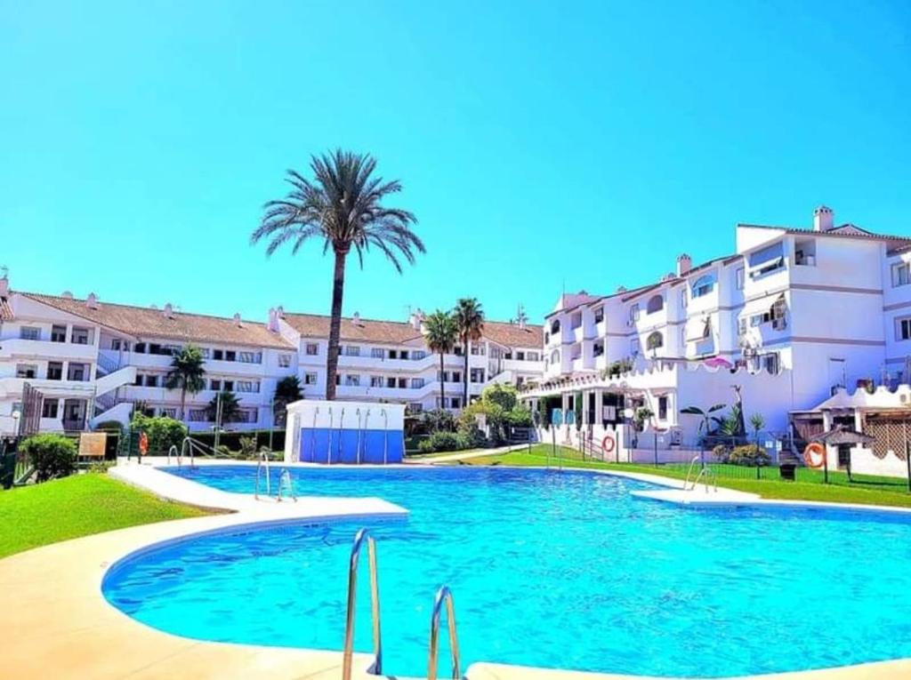 a large swimming pool in front of some buildings at Apartamento en Mijas con Terraza, capacidad para 5 personas in Málaga