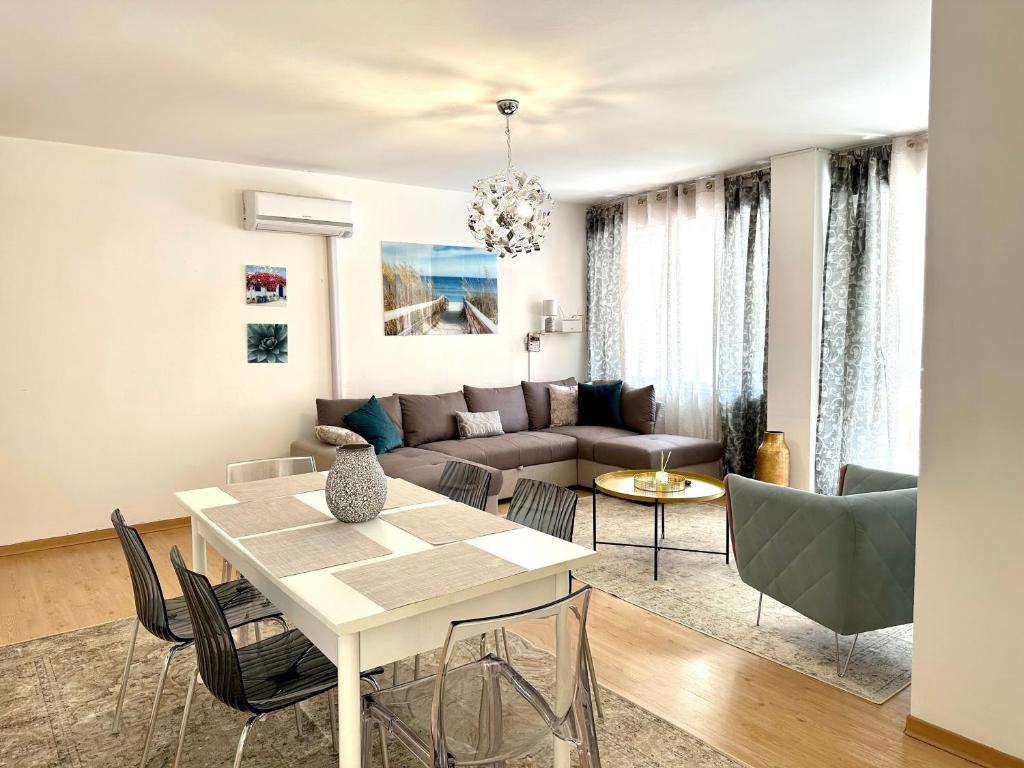sala de estar con mesa y sofá en Apartament Sabbiadoro Center, en Lignano Sabbiadoro