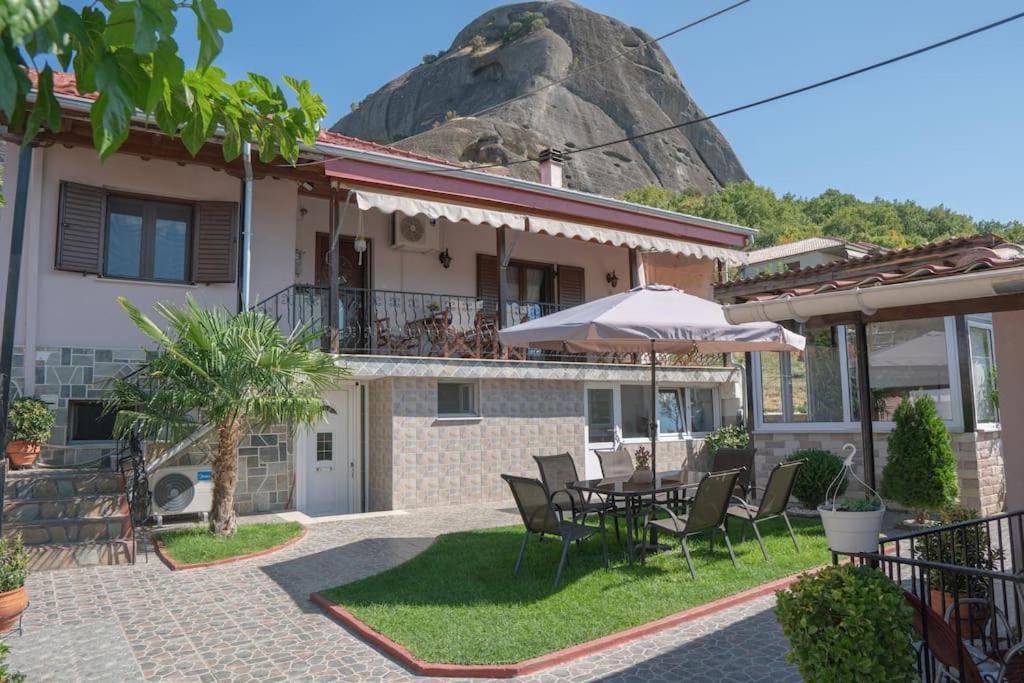 a house with a table and chairs and a rock at Villa Nefeli in Kalabaka