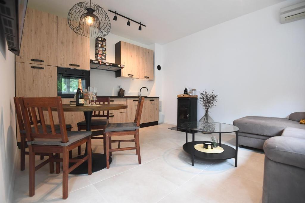 a living room with a table and a kitchen at Kala House - BRAND NEW!! in Zadar