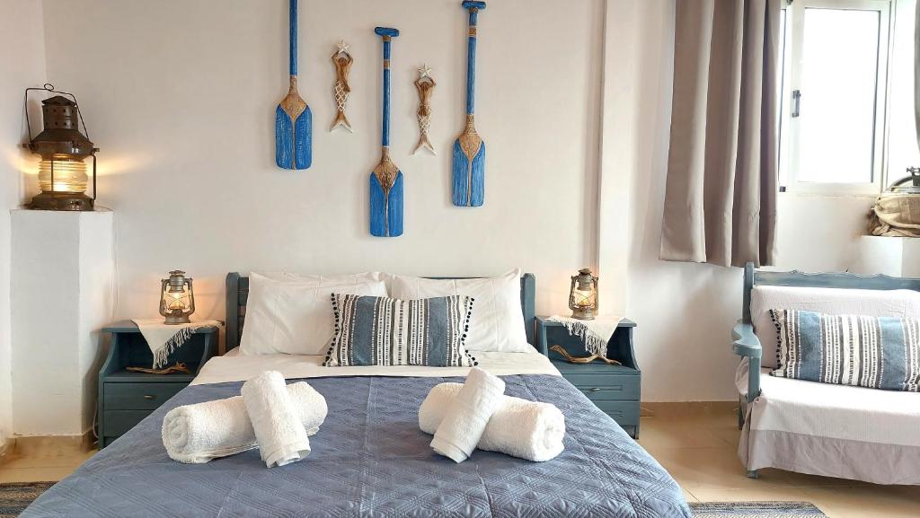 a bedroom with a bed with blue vases on the wall at Captain's Sea View in Vathi