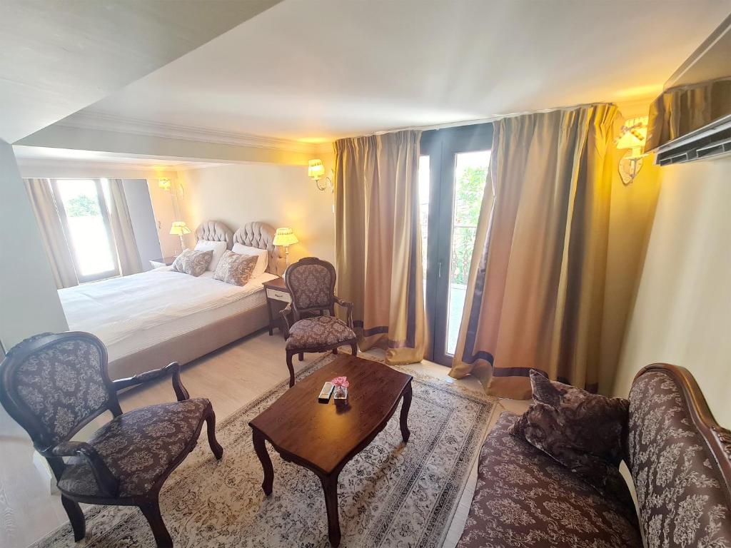 a bedroom with a bed and a table and chairs at SOFIA BOUTIQUE HOTEL in Kyrenia