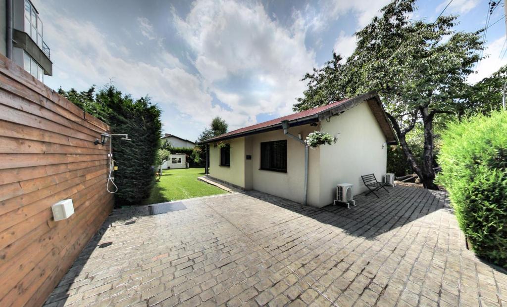 a house with a fence and a brick driveway at VARNA KABAKUM HOUSE in Varna City