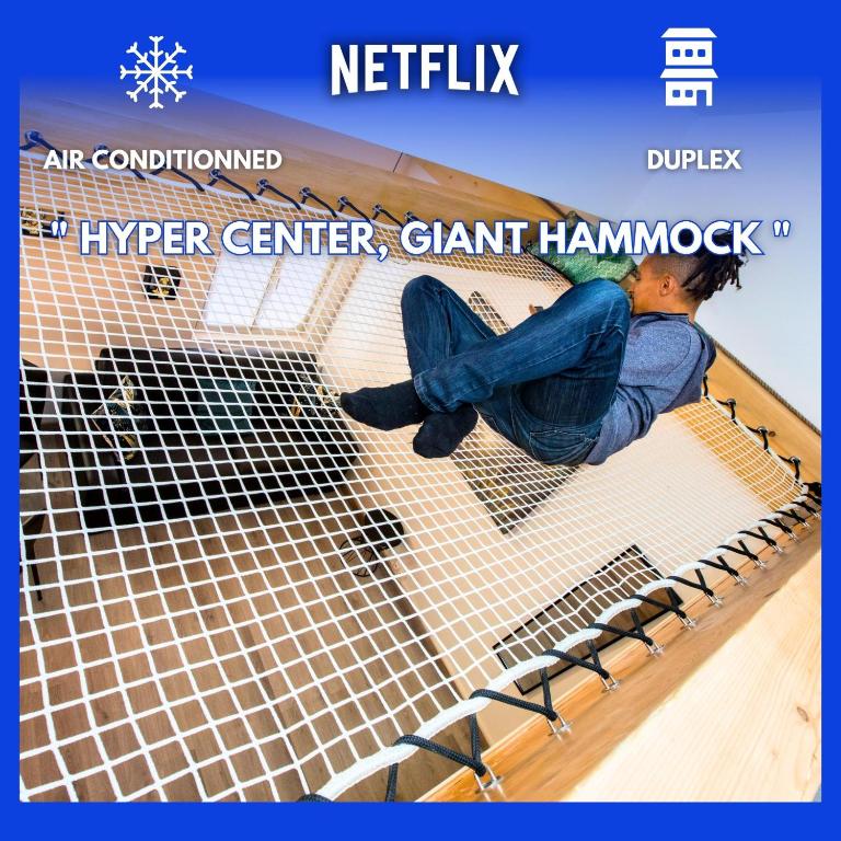 Hotel Duplex : Plage 300m, Clim, Netflix, a person laying on a net on a bed at Duplex : Plage 300m, Clim, Netflix in Cannes