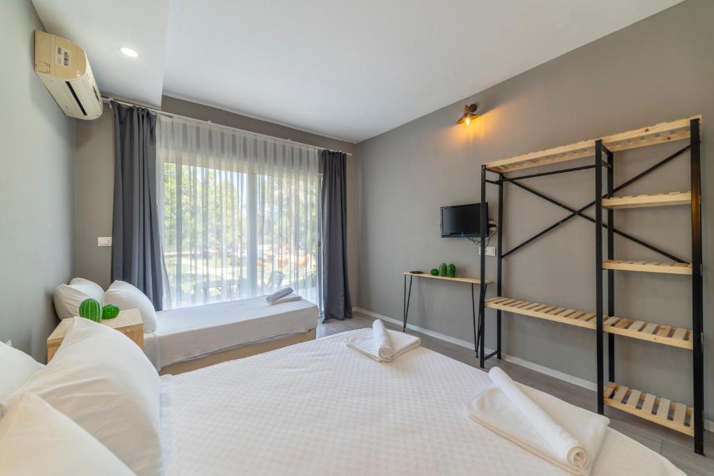 een slaapkamer met een groot wit bed en een raam bij Gızlıkoyhotel in Antalya