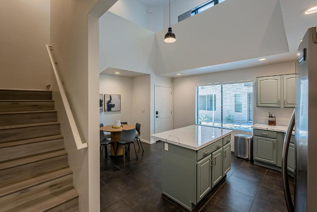 a kitchen with a island and a table in a room at Modern 3 Bed - 3 Bath Townhouse w/ rooftop deck in Phoenix