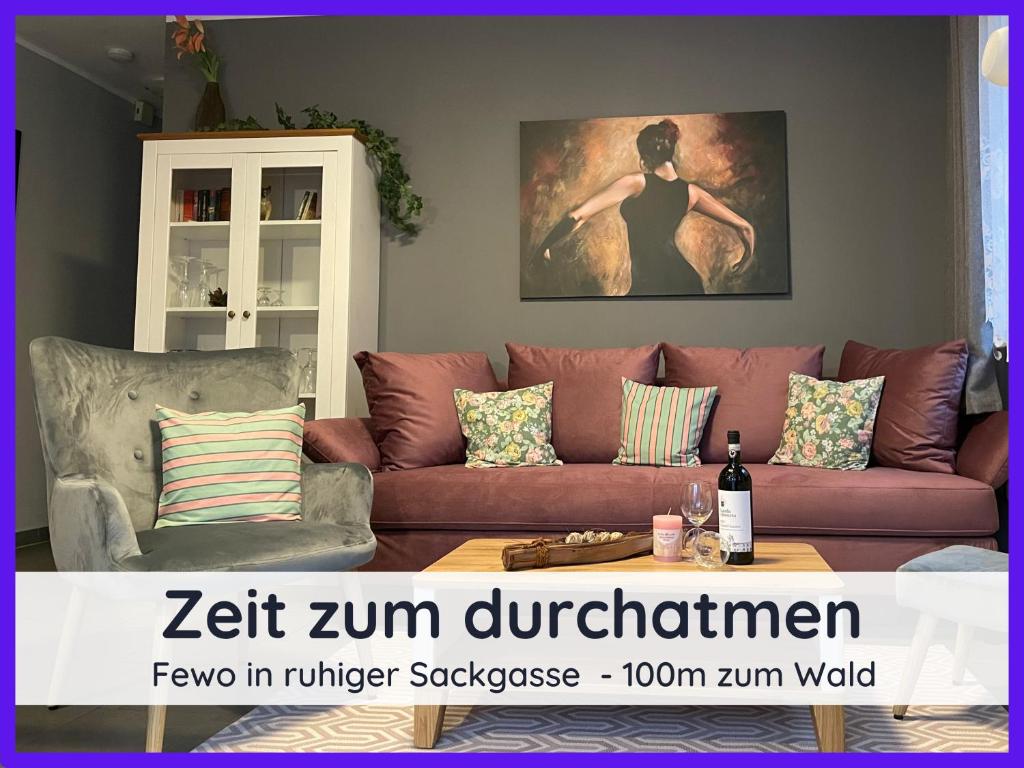a living room with a couch and a table at Der Fuchsbau - Fewo LePetit - im sonnigen Harz - Hunde willkommen - 100m bis zum Wald - FREE WLAN in Bad Sachsa