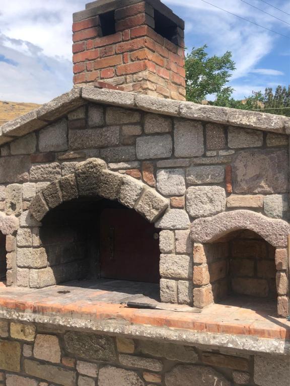 an outdoor brick oven with two openings in it at Gregory's Village in Platy