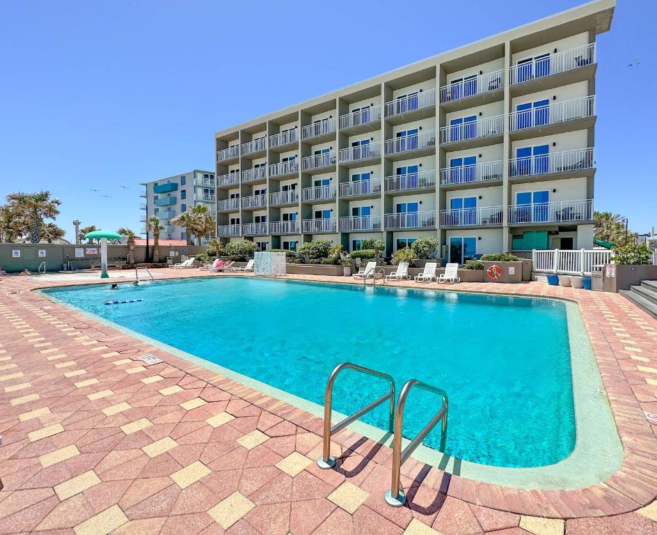 a large swimming pool in front of a building at Boardwalk Inn and Suites in Daytona Beach