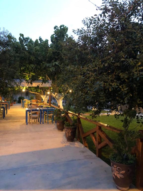a patio with tables and chairs in a park at Gregory's Village in Platy