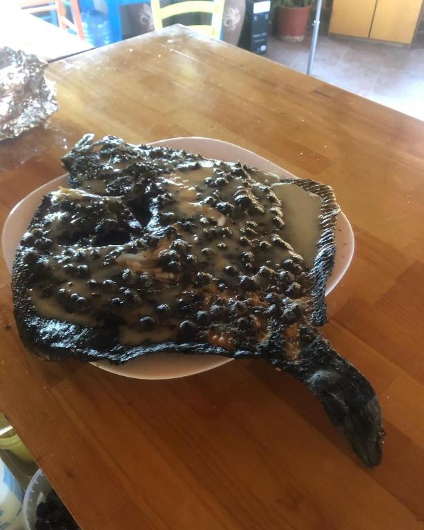 a piece of food on a plate on a table at Gregory's Village in Platy
