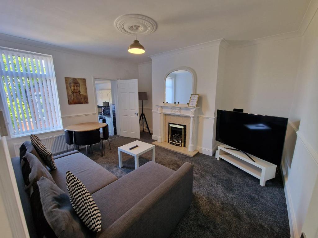 a living room with a couch and a tv at Luna Apartments Newcastle Gateshead 1 in Gateshead