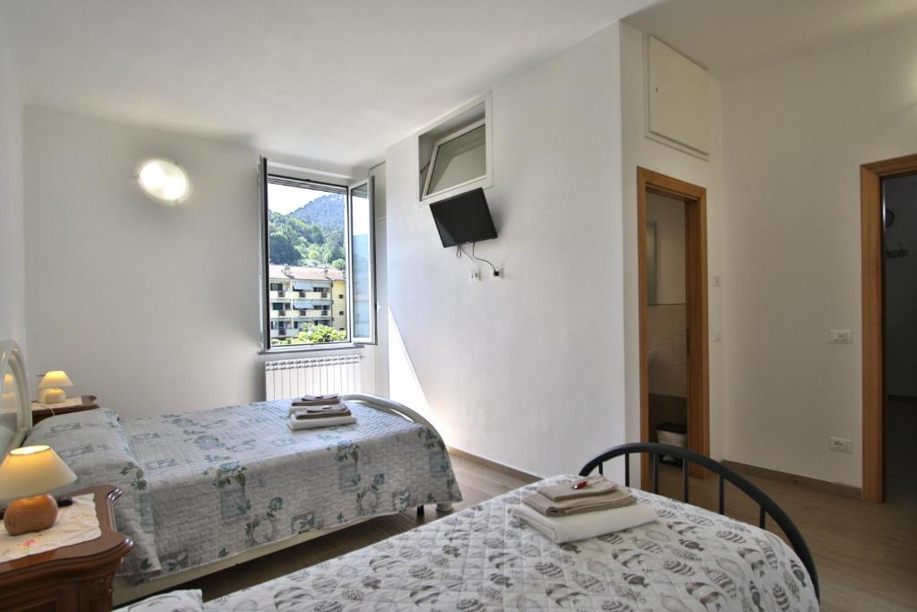 um quarto com 2 camas e uma janela em Appartamento sole&mare em Levanto