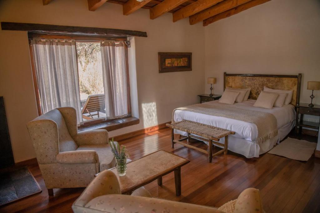 a bedroom with a bed and a couch and a chair at Posada Rural La Matilde in San Javier