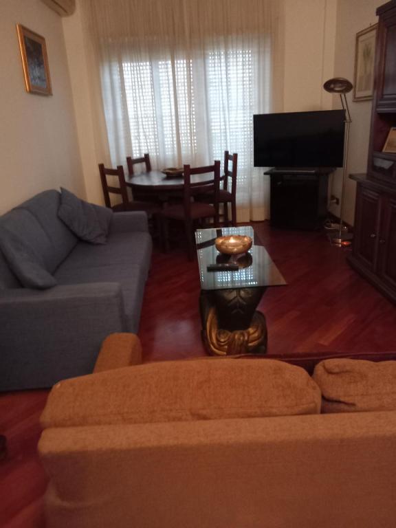 uma sala de estar com um sofá e uma mesa em Montagnola House em Roma