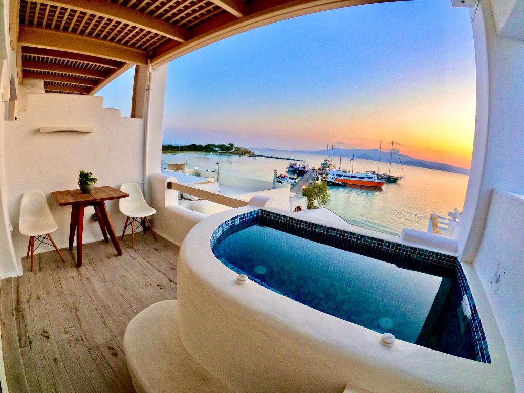 a pool in a house with a view of the water at Apartments enosis, Poseidon in Agia Anna Naxos