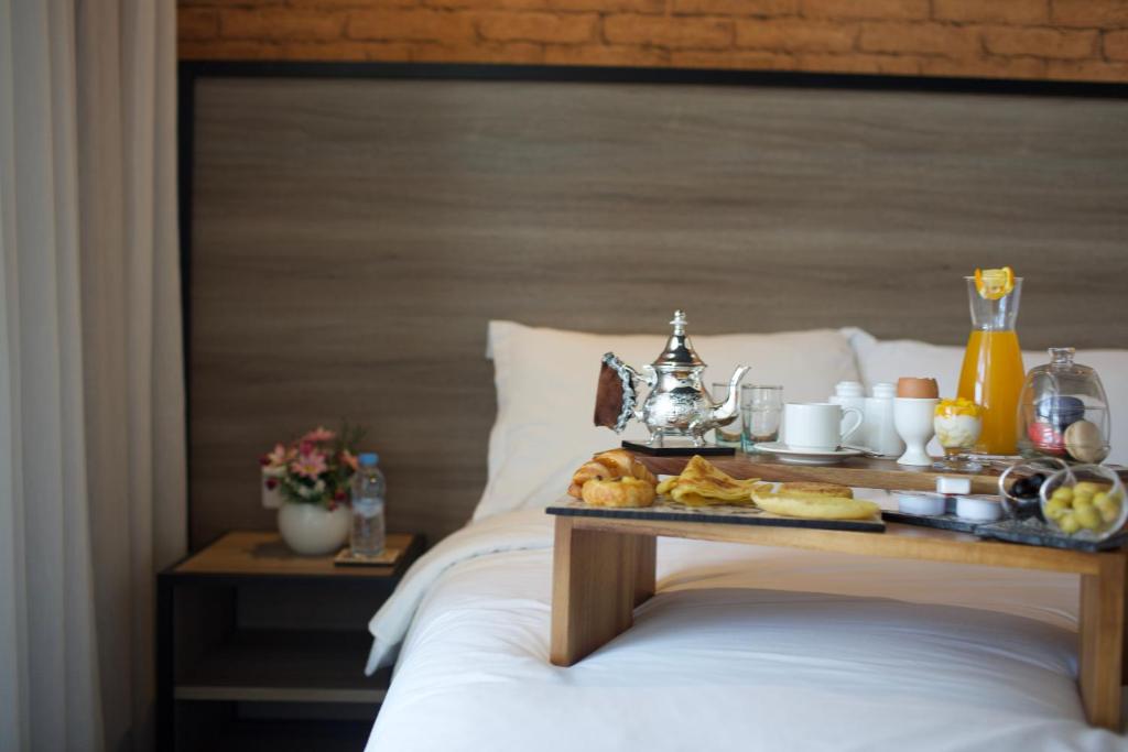 a tray of food on top of a bed at ONOMO Hotel Tanger Med in Tangier