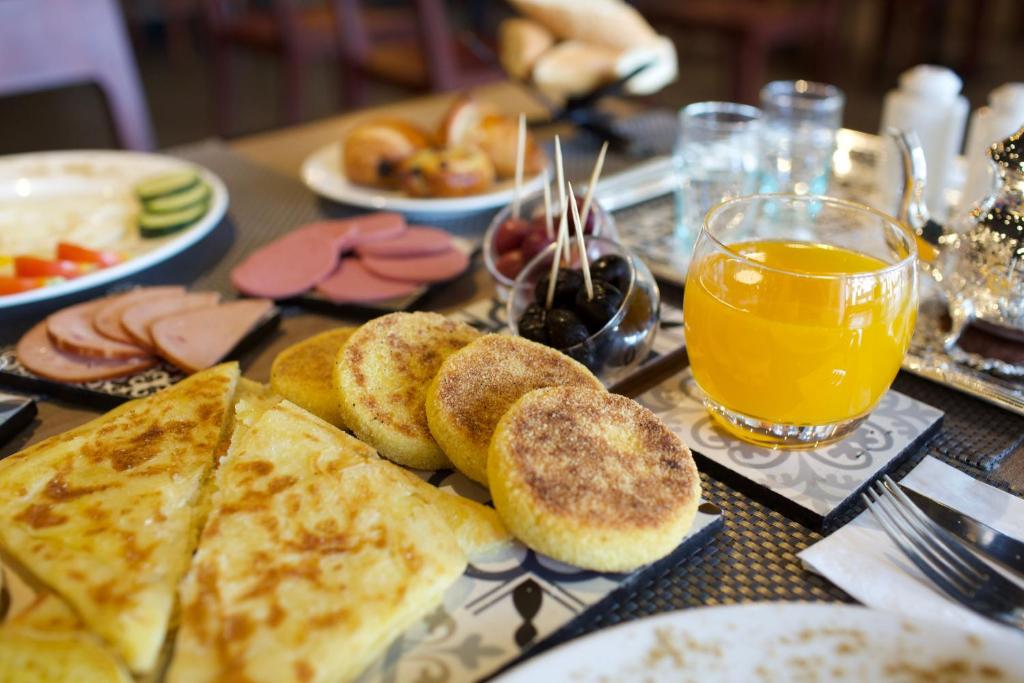 a table with bread and a glass of orange juice at ONOMO Hotel Tanger Med in Tangier