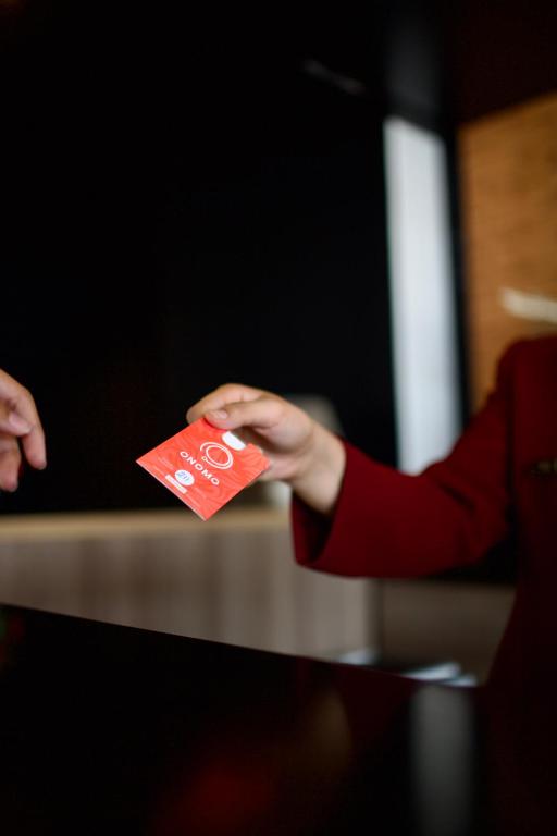 a person is holding a red credit card at ONOMO Hotel Tanger Med in Tangier