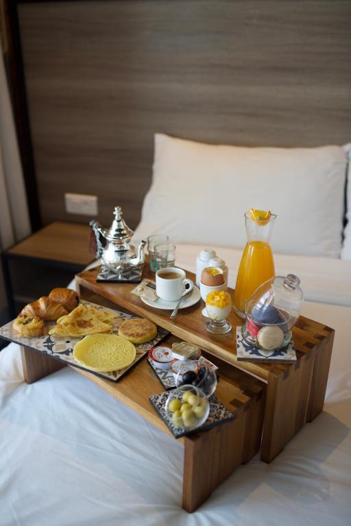 a tray of breakfast foods on a bed at ONOMO Hotel Tanger Med in Tangier