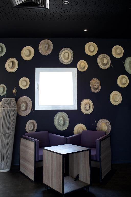a room with a couch and a window and a table at ONOMO Hotel Tanger Med in Tangier