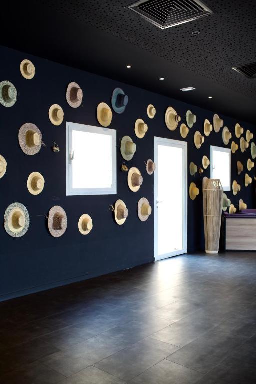 a room with a bunch of hats on the wall at ONOMO Hotel Tanger Med in Tangier