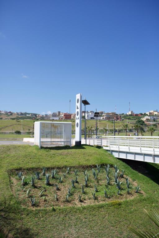a field of plants in the grass next to a bridge at ONOMO Hotel Tanger Med in Tangier