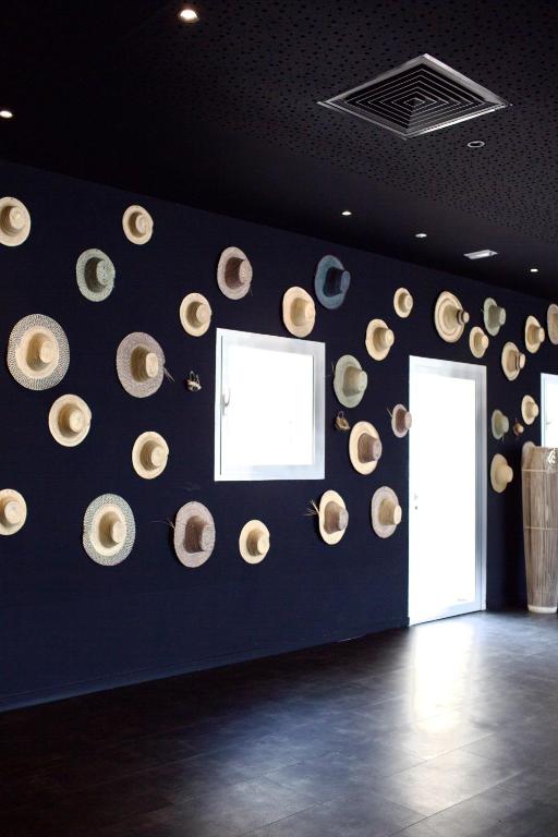 a room with a wall with a bunch of hats on it at ONOMO Hotel Tanger Med in Tangier