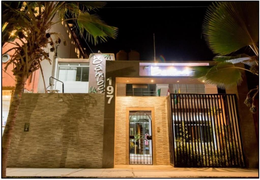 a building with a gate in front of it at night at Nuevo Bamboo in Piura