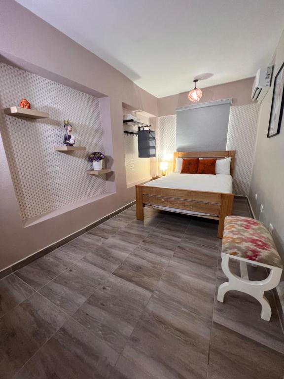 a bedroom with a bed and a bench in it at Hostal 53 Boutique Santo Domingo in Santo Domingo