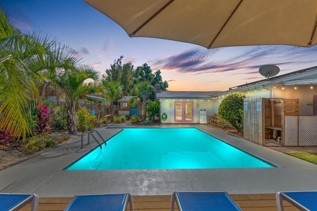 a swimming pool in the backyard of a house at Flirty Flamingo with Private Heated Pool, Game Room, and AMAZING Covered Outdoor Living in Panama City Beach