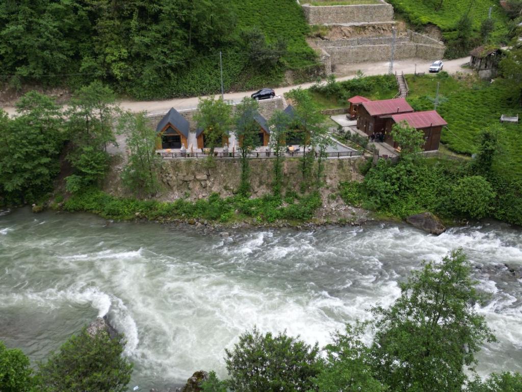 an aerial view of a river with rapids at Çimen apart in Çamlıhemşin