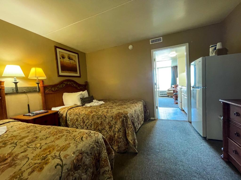 ein Hotelzimmer mit 2 Betten und einem Kühlschrank in der Unterkunft Oceanfront Viking Motel in Myrtle Beach