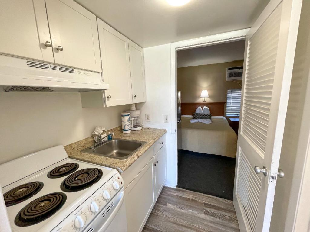 a small kitchen with a sink and a stove at Oceanfront Viking Motel in Myrtle Beach