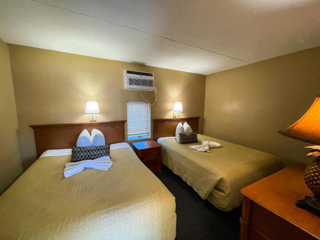 a hotel room with two beds with bows at Oceanfront Viking Motel in Myrtle Beach